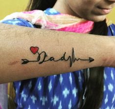 a woman with a heart and arrow tattoo on her arm