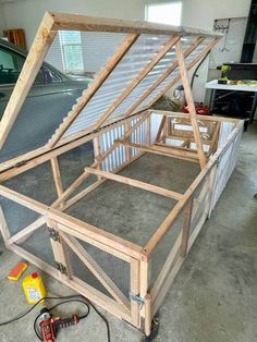 a chicken coop built into the floor in a garage