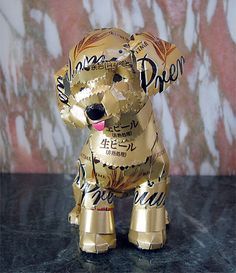 a golden dog made out of beer cans