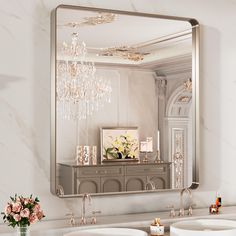 a bathroom with two sinks and a large mirror over it's sink area that has a chandelier hanging from the ceiling