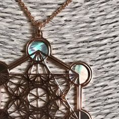 "Metatron in rose gold on 925 silver and black mother of pearl backdrop. The cube known as Metatron takes name by the same Archangel, known as God's scribe. It contains every shape that exists in the universe God has created combining male and female aspects. Within the cube thirteen spheres of female eneregy lies drawing the Fruit of Life, in the middle of which male straight lines are irradiated. In its shapes a triangle and two cubes are also created by six line started from the middle. It al Spiritual Rose Gold Copper Necklace, Rose Gold Spiritual Necklace, Mystical Silver-plated Copper Necklace, Mystical Silver-color Copper Necklace, Mystical Silver-colored Copper Necklace, Lies Drawing, Pearl Backdrop, Universe God, Pearl Background