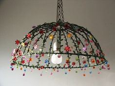 an apple is hanging from a birdcage decorated with flowers