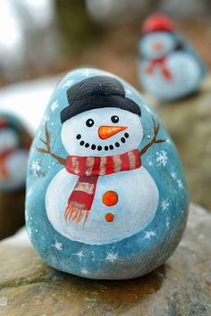 some painted rocks with snowmen on them