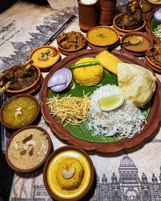 a table topped with plates filled with different types of food and condiments on top of it