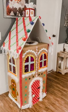 a cardboard gingerbread house sitting on the floor