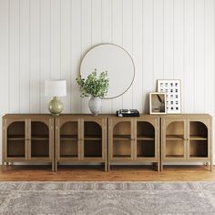 a living room with a large mirror and wooden shelves on the wall next to a rug