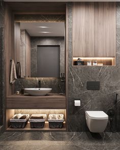 a modern bathroom with marble walls and flooring, along with an open shelf above the toilet