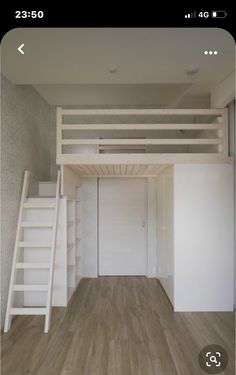 an empty room with a ladder to the loft