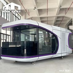 a white and purple train car sitting inside of a building