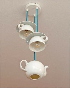 teapots and cups are hanging from the ceiling