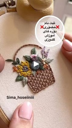 someone is stitching flowers on the back of a handbag with a message bubble