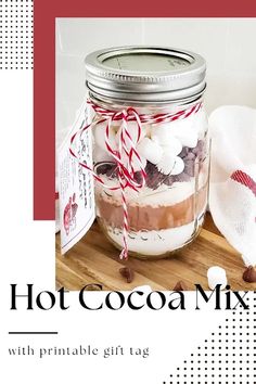 a jar filled with hot cocoa mix sitting on top of a wooden table