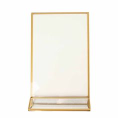 an empty glass and gold frame on a white background