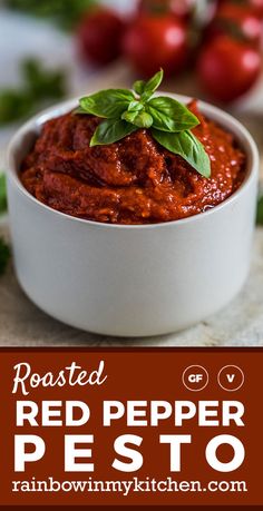 roasted red pepper pesto in a white bowl with basil on top and text overlay reading roasted red pepper pesto