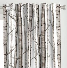 the curtain is hanging in front of a window with white curtains and trees on it