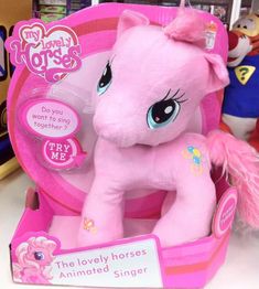 a pink pony toy sitting inside of a box