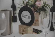 a table topped with lots of wine bottles and glasses