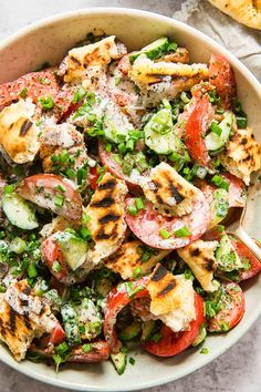 a bowl filled with grilled vegetables on top of a table