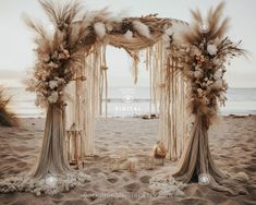 an outdoor wedding ceremony setup on the beach with pamolite flowers and feather decorations