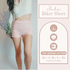 a woman in pink shorts and white shirt holding a lavender plant with the words fade biker short on it