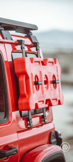 the back end of a red jeep with its doors open