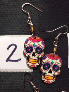 HANDMADE SUGAR SUGAR EARRINGS set 5 --choose from #1-6 and that exact one you will receive :) If you would like many please message us :) DETAIL IS AMAZING! NOT ONE IS THE SAME! COOLER IN PERSON! Set 5 Halloween Skull Print Earrings, Halloween Skull Print Skull Earrings, Handmade Halloween Earrings Gift, Multicolor Skull Jewelry For Day Of The Dead, Day Of The Dead Multicolor Skull Jewelry, Halloween Skull Print Earrings Gift, Bohemian Halloween Earrings As Gift, Bohemian Earrings For Halloween Gift, Bohemian Halloween Gift Earrings