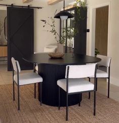 a dining room table with chairs around it