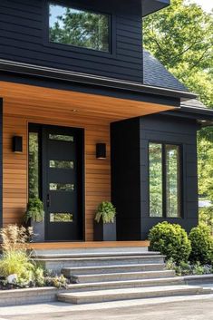 a black house with steps leading up to the front door