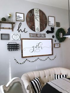 a living room filled with furniture and lots of clocks on the wall above it's coffee table