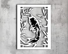 a paper cut out of a koi fish with bamboo leaves on the bottom and sides