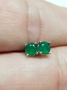 Thanks for shopping our vintage estate store. We tend to sell well below wholesale and truly hope you enjoy all of our items. Many of the items are one of a kind, so please enjoy scrolling through the pictures and hopefully something will catch your eye. Brown spots are from reflections or camera. Nice estate 14k white gold natural .50ct emerald studs. They are nice in color. Custom made in our shop. Little darker than some emeralds, but I love these.  Retails $549 on sale $199 Size: 4.4mm Weight: .74 grams Carat: .25ct per stud Clarity: I1/2 Marked 14k and backs are included. Classic Emerald Earrings For Anniversary, Vintage Emerald Earrings For Anniversary, Emerald Round Earrings For Anniversary, Round Emerald Earrings For Anniversary, Vintage Round Cut Earrings For Gift, Classic Round May Birthstone Earrings, Classic Round Earrings For May Birthstone, Aaa Quality Round Emerald Jewelry, Hallmarked Round Emerald Earrings