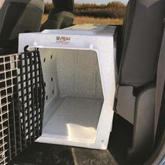 the back end of a vehicle with its cargo compartment open and an animal cage in it