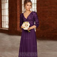 a woman in a long purple dress holding a white bouquet and looking at the camera