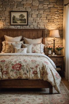 a bedroom with a stone wall and wooden headboard