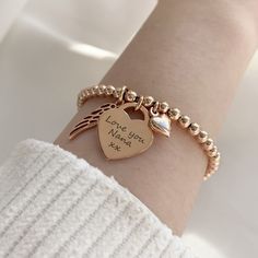 It's the RETURN memorial bracelet - designed to commemorate cherished memories. This beautiful rose gold vermeil bracelet combines a rose gold heart charm which can be engraved with a loved one's name, alongside a pretty rose gold angel wing and a dainty rose gold heart charm. The rose gold vermeil heart charm measures 16mm across the front of the heart, perfect for engraving a name or message, and sits centrally on a rose gold vermeil ball bracelet crafted with 4mm beads. The pretty rose gold v Adjustable Rose Gold Charm Bracelet With Heart Charm, Personalized Rose Gold Charm Bracelet As A Gift, Personalized Rose Gold Charm Bracelet As Personalized Gift, Personalized Rose Gold Charm Bracelet, Personalized Rose Gold Charms As A Gift, Personalized Rose Gold Charms As Gift, Personalized Rose Gold Bracelets For Mother's Day, Mother's Day Gift Rose Gold Charm Bracelet, Rose Gold Heart Charm For Valentine's Day