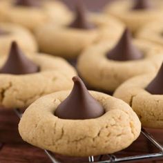 some cookies with chocolate on top are sitting on a cooling rack and ready to be eaten