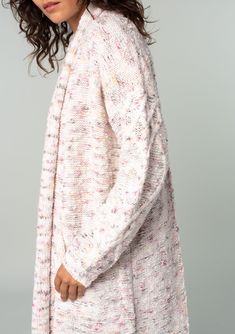 An ultra-cozy long shawl cardigan spun from a berry pink speckled knit. Speckled Oversize fit Long sleeve with cable knit accent Long duster length Shawl collar Side patch pockets Open front Cable knit accent along the back Bohemian long cardigan Laid-back and slouchy yet effortlessly polished, this ultra-soft duster cardigan is knit from a berry pink speckled yarn. Featuring classic cable knit details along the back and essential side pockets. The shawl collar adds warmth and coziness. Model is Pink Knit Cardigan For Fall, Cozy Pink Cable Knit Outerwear, Pink Cable Knit Long Sleeve Cardigan, Pink Long Sleeve Cable Knit Outerwear, Cozy Cable Knit Relaxed Fit Cardigan, Oversized Pink Cable Knit Cardigan, Cozy Chunky Knit Pink Cardigan, Pink Textured Knit Cardigan For Fall, Cozy Pink Chunky Knit Cardigan