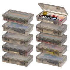 six plastic storage containers with lids and dividers on each side, all containing various items