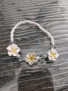 a white beaded bracelet with flowers on it