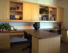 an office with wooden cabinets and desks