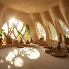 the inside of a house with round windows and potted plants on the floor in front of it