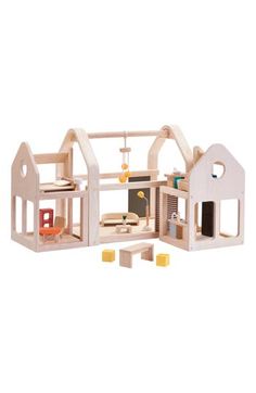 a wooden dollhouse with furniture and accessories for the house, side by side on a white background