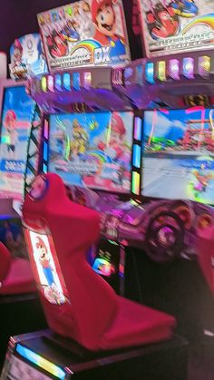 video game machines with mario kart on them in a room filled with other items