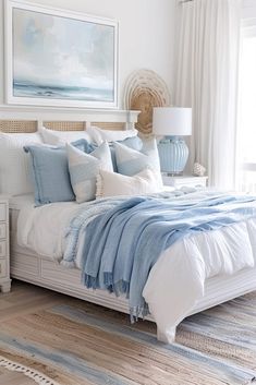 a bed with blue and white pillows in a bedroom