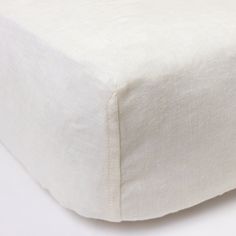 a close up view of a white bed sheet