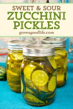 three jars filled with pickles on top of a blue table cloth and the words sweet & sour zucchini pickles