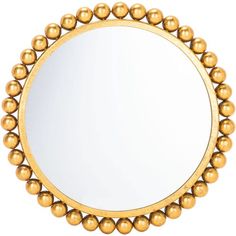 a round mirror with gold balls on the rim and an oval mirror in the middle