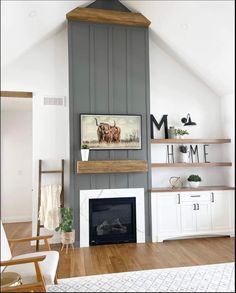 a living room filled with furniture and a fire place in front of a wall mounted tv