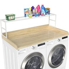 a white washer and dryer sitting next to each other on top of a wooden counter