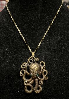 an octopus necklace is displayed on a mannequin